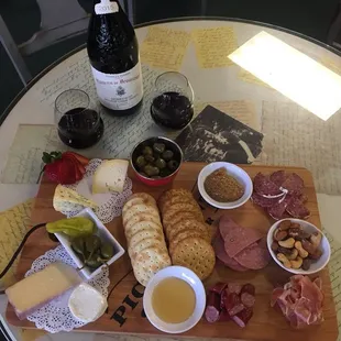 an assortment of meats, cheeses, and olives