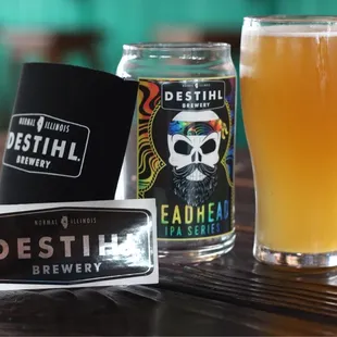 a glass of beer and a can