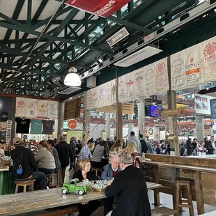 Two big picnic tables and bar stools all around the fence.