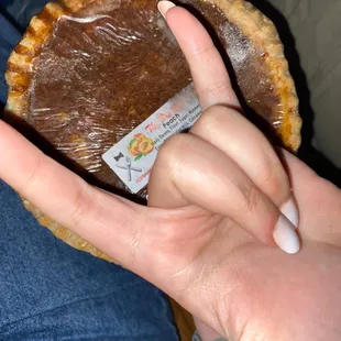 a hand holding a pie