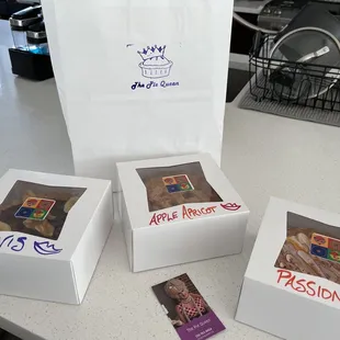 three boxes of pastries on a counter