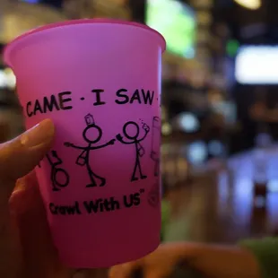 someone holding a pink cup