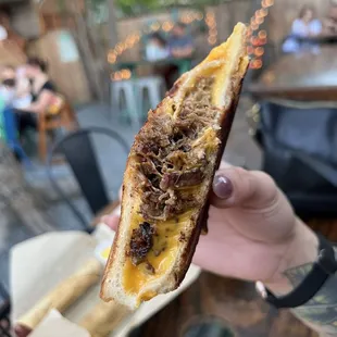 a person holding a piece of food