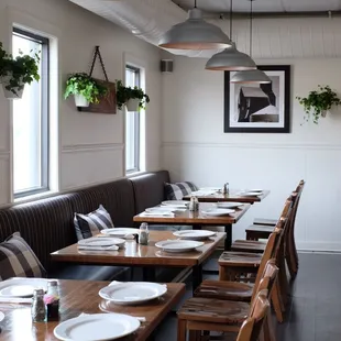 a long dining room with wooden tables