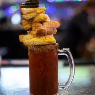 a bloody drink with a stack of french fries on top
