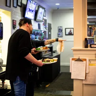 a man serving food in a restaurant