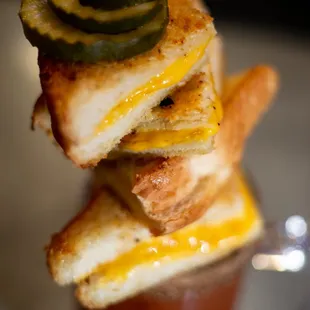 a hot dog with pickles and cheese