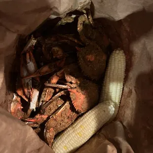 Dozen large crabs and two ears of corn