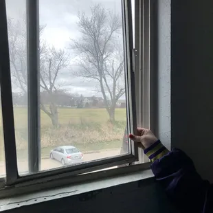 window in stairwall has been broken for over 10 months- doesn't close completely