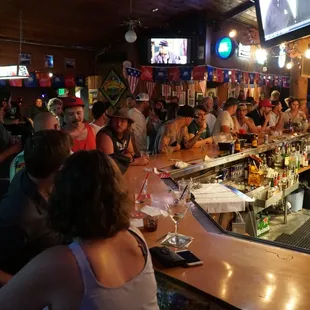 a large group of people sitting at the bar