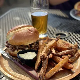 a plate of fries and a pulled pork sandwich