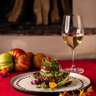 This is our Heirloom Tomato Salad, with basil pesto, goat cheese mousse balsamic glaze. This dish has us very excited for summer and our vis