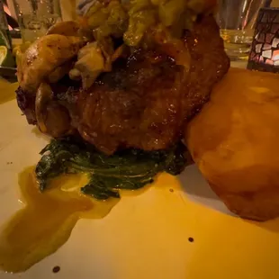 A perfectly cooked ribeye steak topped with flavorful sautéed spinach and a hint of green chili. Perfect!