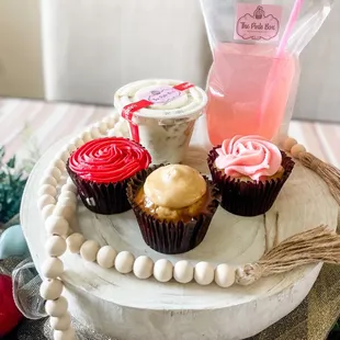 Cupcakes- Strawberry (red icing), Carmel (ivory icing) &amp; signature cupcake (pink icing), banana pudding &amp; homemade pink lemonade !