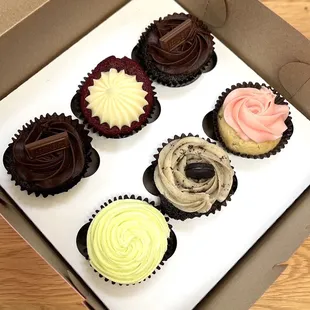 a dozen cupcakes in different flavors