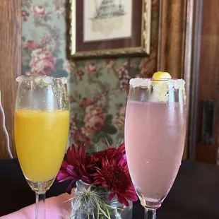 two glasses of champagne and a glass of orange juice