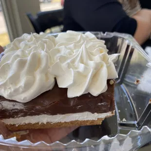 a piece of cake with whipped cream on top