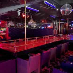 a bar with a disco ball in the background