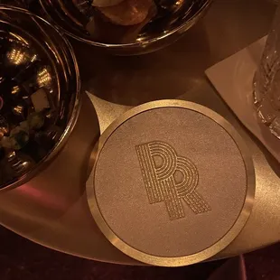 a silver plate with a monogram on it