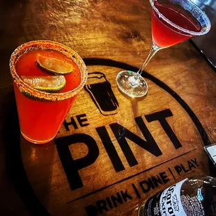 two cocktails on a wooden table