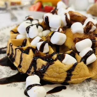Belgian Waffle with marshmallows, spiced apples and topped with chocolate sauce.