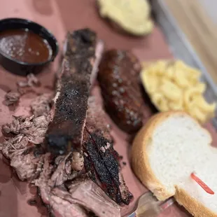 a barbecue platter with meat and sides