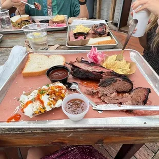 Two meet dinner with brisket and pork ribs.