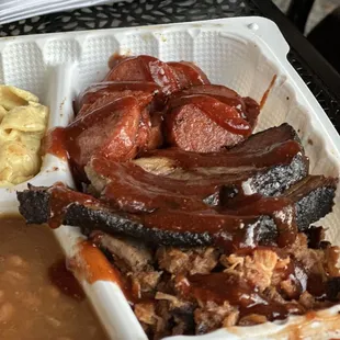 3 meat platter -  Smoked Pulled pork, Texas style brisket, and smoked sausage with classic baked beans and a pasta salad.