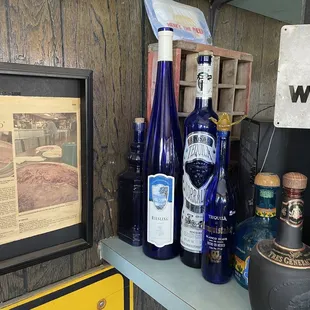 Note: no dust on the prey blue bottles