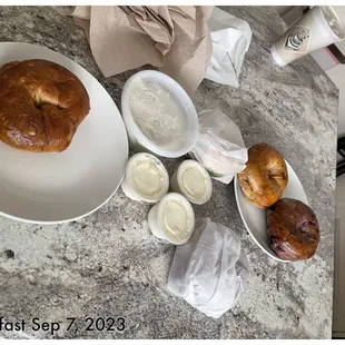 a table with bread, butter, and other food items