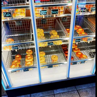 a variety of donuts in a display case