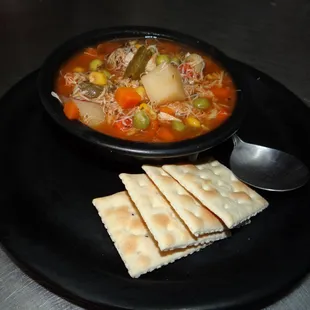a bowl of soup and crackers