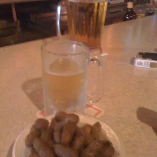 a plate of food and a glass of beer