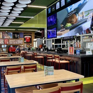 Downstairs view of the bar and tvs