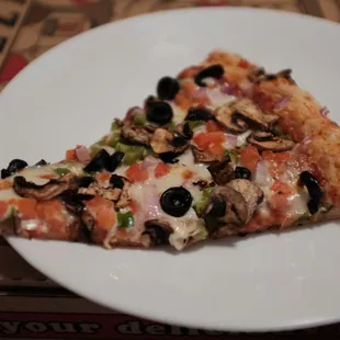 a slice of pizza on a plate