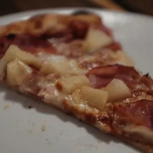 a slice of pizza on a plate