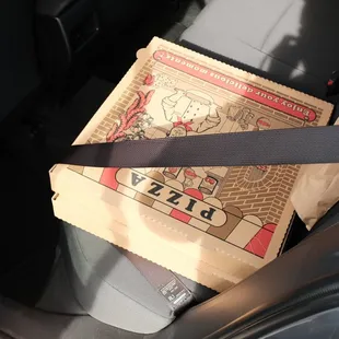 large pizzas are around the size of a seat at the back of my car.
