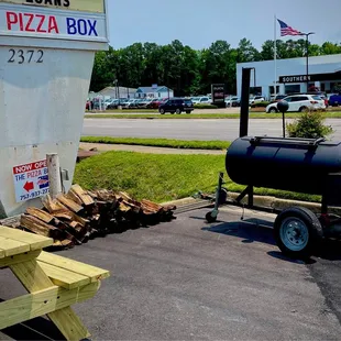 Outdoor signage, picnic area, and smoker set up - upper lot.
