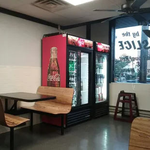 a table and chairs in front of a vending machine