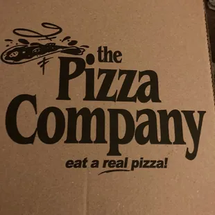 a person holding a box of pizza