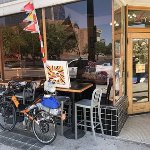 Exterior: My eBikeKit-assisted CruzBike parked alongside chairs  on Stanton street