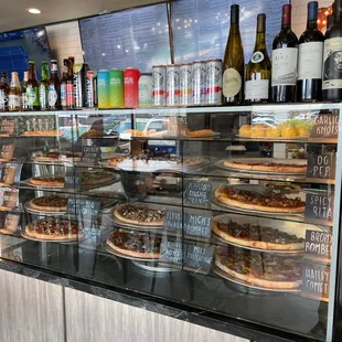 a variety of pizzas on display