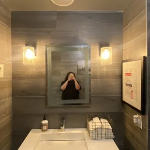 a woman taking a selfie in the mirror