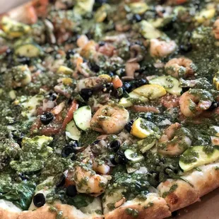 Pizza with shrimp n veggies and pesto sauce