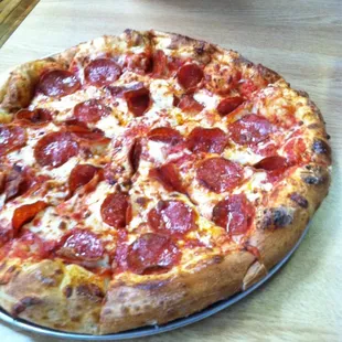 a pepperoni pizza on a table