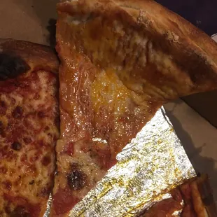 Extremely thin and greasy pizza. The hole towards the end "is normal when you hand make dough..."