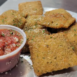 a plate of crackers and a bowl of sauce