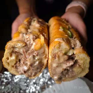 a person holding a sandwich