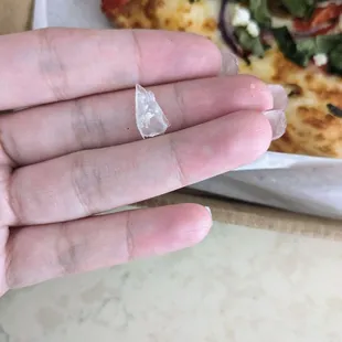Bit into a hard piece of plastic on my pizza