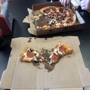two slices of pizza in a box